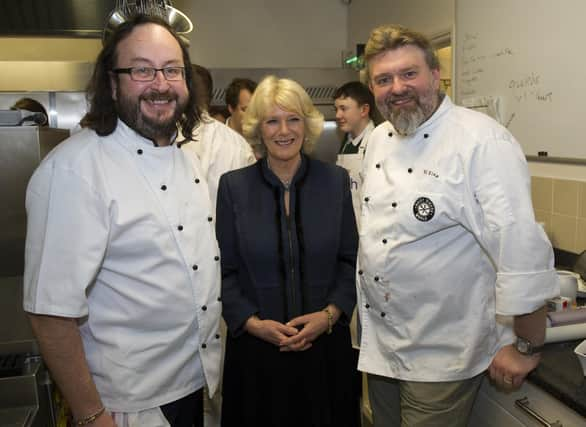 LONDON, ENGLAND - JANUARY 27: Camilla, Duchess of Cornwall (C) and Hairy Bikers Dave Myers (L) and Si King (R) attend the British Food Fortnight Secondary School Competition at Clarence House, on January 27, 2011 in London, England. The students prepared a meal for Camilla, Duchess of Cornwall and guests as part of the competition prize. (Photo by Arthur Edwards - WPA Pool/Getty Images)