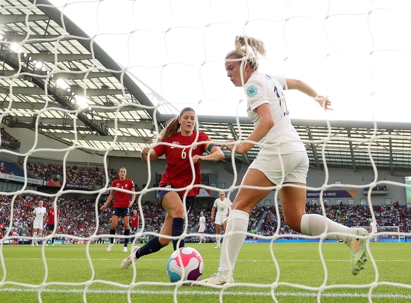 Lauren Hemp scores England's second goal under pressure from Maren Mjelde.