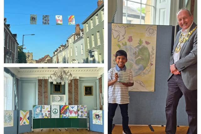 A series of special flags designed by Warwick school children have been hung this week as part of the town’s VE Day celebrations. Left two photos show the flags (photos by Warwick Town Council) and right shows Adhav Navinan from Emscote Infant School who designed the overall winning flag, with the Mayor of Warwick, Cllr David Skinner (photo by Emscote Infant School).