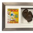 Warwick boxing legend Randolph Turpin's gloves, which he wore during his preparation for his fight against Sugar Ray Robinson which he won to become the Middleweight Champion of the World. They are framed with a programme cover and ticket from the fight, which took place ay Earls Court in London on July 10, 1951.