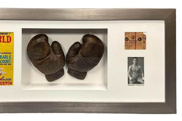 Warwick boxing legend Randolph Turpin's gloves, which he wore during his preparation for his fight against Sugar Ray Robinson which he won to become the Middleweight Champion of the World. They are framed with a programme cover and ticket from the fight, which took place ay Earls Court in London on July 10, 1951.