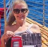 Ex Rugby resident Susan Pavis Jennings proudly shows off her calendar while yachting in Hawaii.