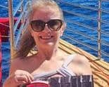 Ex Rugby resident Susan Pavis Jennings proudly shows off her calendar while yachting in Hawaii.