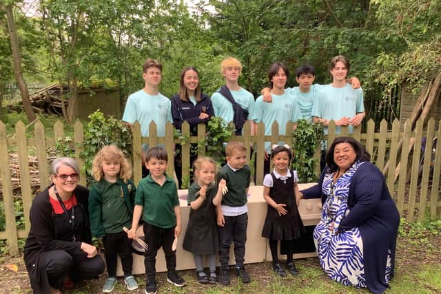 Students with staff and children at Oakfield.