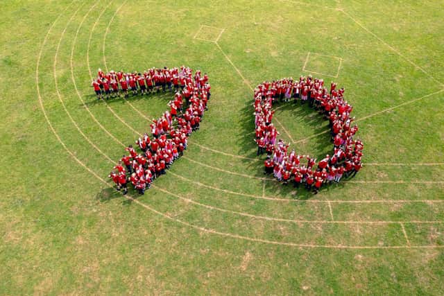 The school will be sending a book to the Queen, featuring a piece of writing or drawing by every pupil, with an aerial photo of the pupils forming the number 70, taken by photographer Tim Atherton, on the front cover. Photo by Tim Atherton