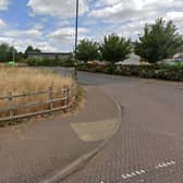 The land to the left of the access road to Cawston's shops will now be developed for houses, despite opposition for residents. Photo: Google Street View.