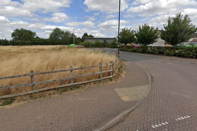 The land to the left of the access road to Cawston's shops will now be developed for houses, despite opposition for residents. Photo: Google Street View.