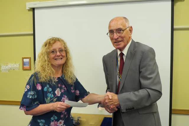 Outgoing president Keith Talbot presenting cheque to Rachael Stevens of Safeline.  Photo supplied