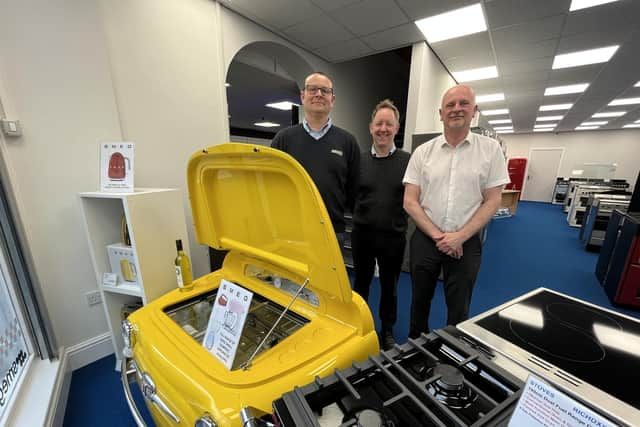 Three of the current team at Carvells - Scott Young, Jamie Ward and John Bowles - are pictured in their extended showroom with the eye-catching Smeg drinks cooler in the shape of a Fiat 500.