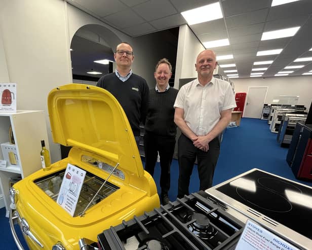 Three of the current team at Carvells - Scott Young, Jamie Ward and John Bowles - are pictured in their extended showroom with the eye-catching Smeg drinks cooler in the shape of a Fiat 500.