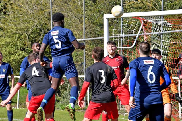 Jamal Clarke (No5) heads Rugby's first goal v Rothwell