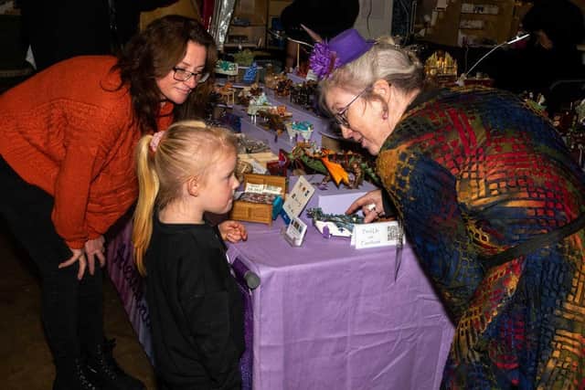 Visitors to a Miniatura show chat to Alexandra Blythe of Mayhem Magic. Picture supplied.