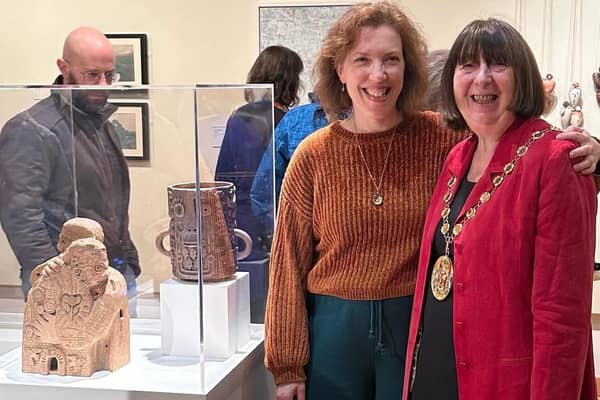 Leamington Open 2024 Exhibition winner Laura Adkins with Warwick District Council chair Cllr Sidney Syson. Laura's winning work The Hug is pictured to the left of her.