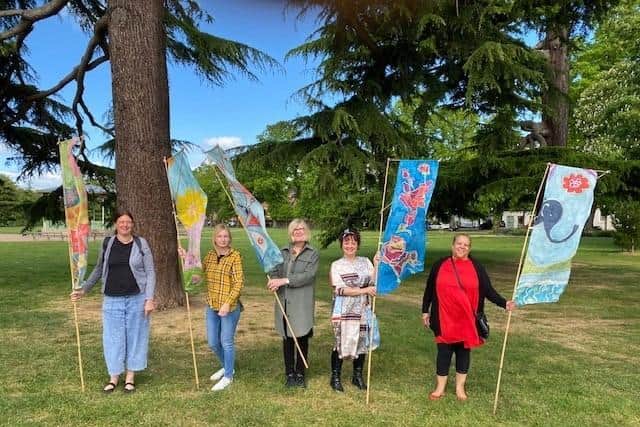 Officers from Warwick District Council with artist Libby Esler, holding the style of flags that will be produced by young people in the workshops. Picture submitted.