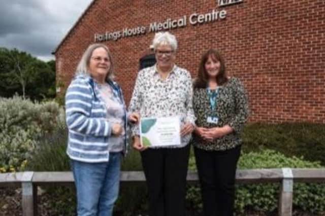 Eileen Edwards, a trustee of the Friends of Hastings House, receives a cheque from Cllr Anne Prior of Wellesbourne Parish Council, which will primarily help to fund the work of Wendy Walters, pictured right.