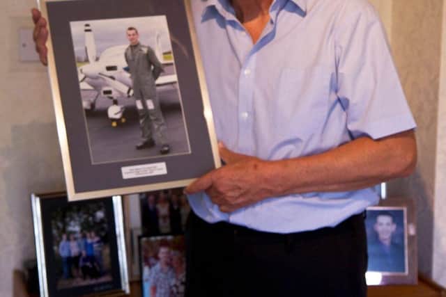 Peter holding treasured photo of Stephen