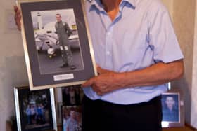 Peter holding treasured photo of Stephen