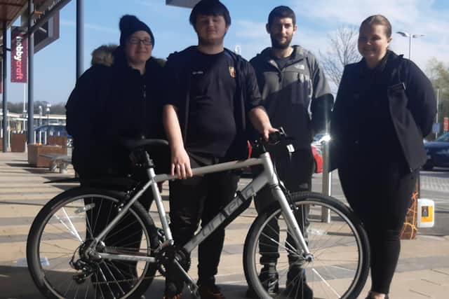 Joel with his new bike, pictured with (left-right) mum Rebecca, dad Liam and Emily, deputy manager of the Rugby branch of Halfords.