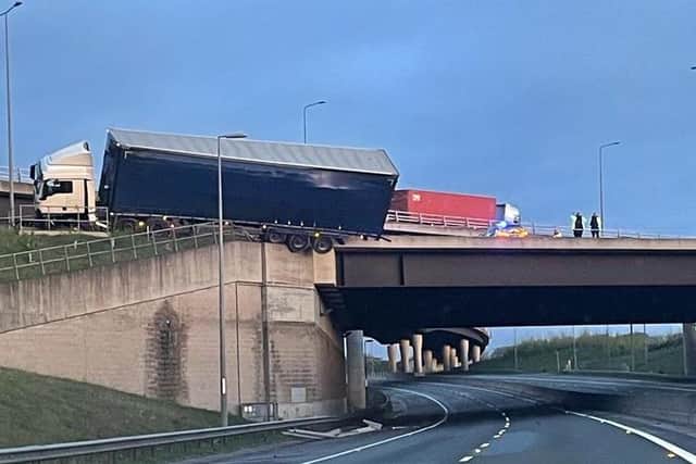 The lorry perched on the side of the motorway.