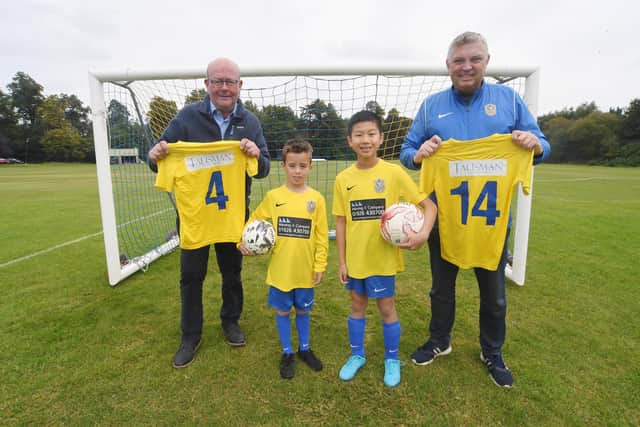 The new boys’ kit for Kenilworth Wardens Junior Football Club, sponsored by Talisman Shopping Centre and Wareing & Company. From left: Bill Wareing, Oliver Hales (7), Oscar Hua (11) and Andrew Watts. Photo supplied
