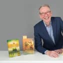 Dr Justin Newland with some of his novels. Picture supplied.
