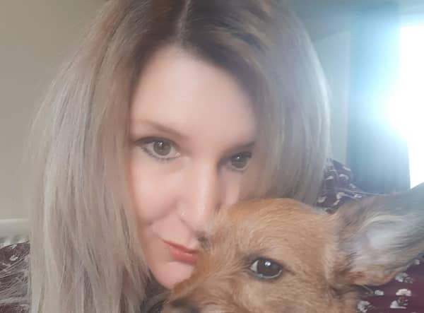 Cuddling my little dog Luna, who has not left my side.