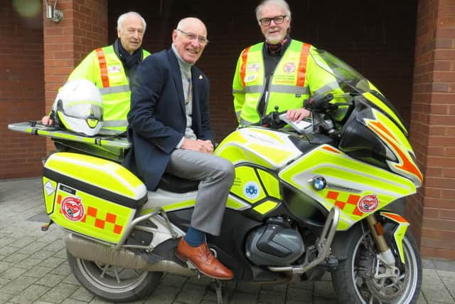 Left to right: Alan Brickwood, Warwick Rotary President Keith Talbot on WSBB’s BMW 1250RT bike and Martin Williams. Photo supplied