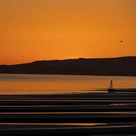 The sun sets over Camber Sands.