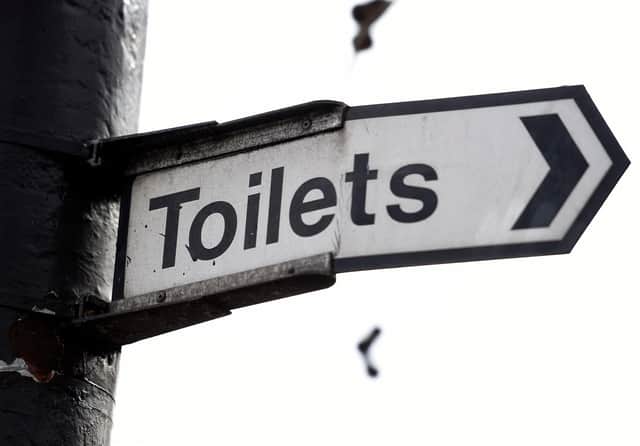 A sign for public toilets in London. Spending by councils in England on basic services such as public toilets, road safety and pest control has fallen as much as 40\% since 2010.