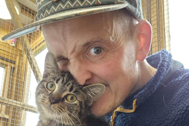 John Lancaster with one of his beloved rescue cats.
