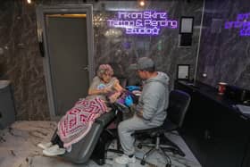 Hilda West celebrates her 100th birthday by getting a tattoo in Ink on Skinz, in Kenilworth from tattoo artist Matty Gardner. Credit Joseph Walshe © SWNS.