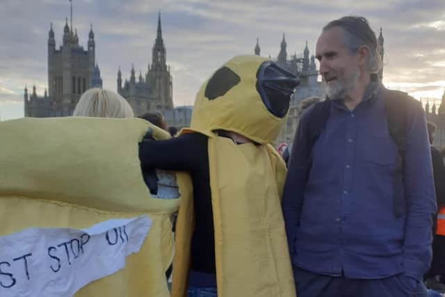 Juliet Carter in her canary costume, talking to environmental activist Roger Hallam