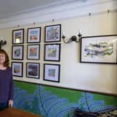Mixed Media artist Carol Wheeler with some of her paintings