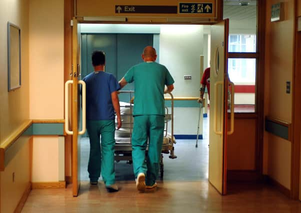 Orderlies push a bed at the Royal Orthopaedic Hospital, Oswestry.