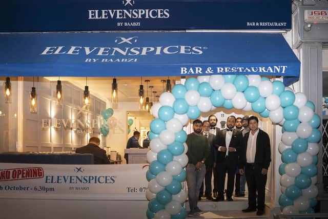 Owners Baabzi Miah and Naseer Hussain outside Eleven Spices in Leamington with members of the team. Picture supplied.