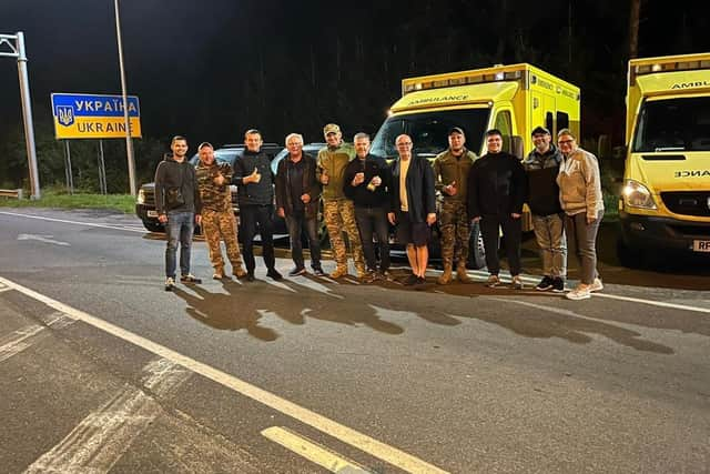 Members of the eight-man team with soldiers at the border between Poland and Ukraine. Picture supplied.