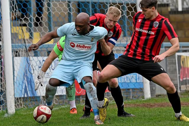 Scorer Michael Taylor battles to turn in the box during Rugby's 5-1 loss to Spalding United (Picture: Martin Pulley)