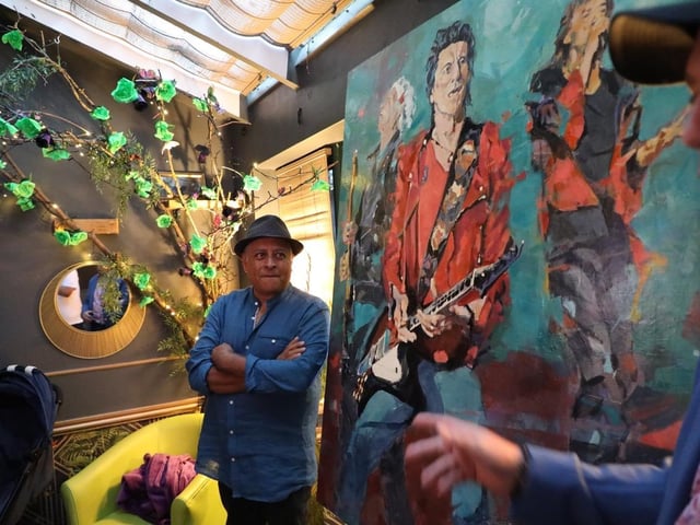 The launch of the art exhibition. Photo shows Rupam Barthakur by the Ronnie Wood portrait. Photo by Bill Bates