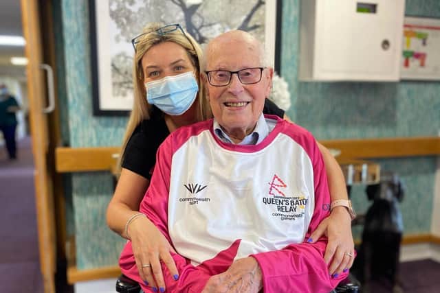 Leamington care home resident John Farringdon, 109,  has been selected as a baton bearer for the Birmingham 2022 Commonwealth Games. He is pictured with the home’s general assistant, Laura Renalson who will accompany him on his leg of the journey. Picture submitted.