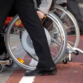 File photo dated 21/11/06 of a person in a wheelchair, as a human rights watchdog has criticised the Government's "slow progress" in efforts to improve the lives of disabled people across the UK.