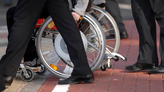 File photo dated 21/11/06 of a person in a wheelchair, as a human rights watchdog has criticised the Government's "slow progress" in efforts to improve the lives of disabled people across the UK.