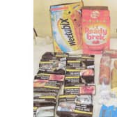 Cereal boxes and the goods that were seized when being smuggled into HMP Hewell. Release date – November 16, 2023.  See SWNS story SWMRprison.  A prison officer who was the ringleader of a smuggling gang supplying inmates with drugs and mobile phones hidden inside boxes of CEREAL has been jailed.   Martin Mills, 34, was caught red-handed trying to smuggle prohibited items into HMP Hewell concealed in packs of Weetabix and Ready Brek.  A court heard he was stopped as he arrived for work at the category B jail near Redditch, Worcs., after his bosses became suspicious in April 2018. Detectives were able to link several other people to the smuggling ring, including prisoners housed on the block Mills worked on. Family members of the lags would pay money into Mills’ bank account and he would then take the prohibited items to work for the prisoners to sell on inside.  Photos show how drugs, phones, SIM cards, tobacco, Rizlas, wads of cash and even a knife were recovered as part of the operation. Mills, of Bromsgrove, Worcs., pleaded guilty to smuggling list A items (drugs) and list B items (mobile phones and associated equipment).  He was jailed for four years at Worcester Crown Court on Monday (13/11).  Mills was sentenced alongside eight other people for conspiracy to bring, throw and convey prohibited items in to the prison. 