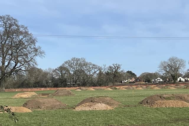 The view of the earthworks from Coventry Road, Dunchurch, looking towards the houses in Cawston Lane. The mounds are easily mistaken for the actions of giant moles but are actually archaeological research in connection with the planning application for the Homestead Link Road.