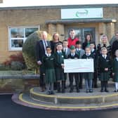 Aria Khunti, Isabella Jackson, Alex Mulhall, Barnaby Williams, Yash Patil, Beau Williams, Sam McCormick, Alexandria Woolley and Niamh Morgan and adults (left to right) – Joe Thackway (Headmaster), Amanda Yates (Teacher), Will Graves (Birmingham Children’s Hospital), Tina Williams (Parent), Laura O’Connell (Parent) and Sam Stapleton (Teacher)