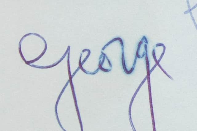 The smudge on George Harrison's signature caused by John Lennon's greasy finger (photo: Hansons)