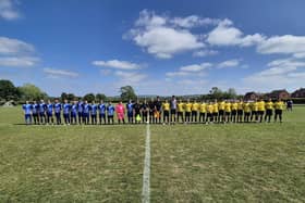 The teams line up before the Cancer Supplementary Cup Final.