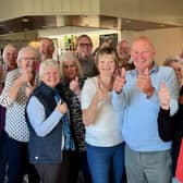 Keith and Janet Tilley, front centre in the pale blue and white jumpers respectively, with some of the volunteers who make the coffee and cake mornings happen, together with some of the more than 70 people who called in on Friday, November 4.