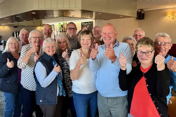 Keith and Janet Tilley, front centre in the pale blue and white jumpers respectively, with some of the volunteers who make the coffee and cake mornings happen, together with some of the more than 70 people who called in on Friday, November 4.
