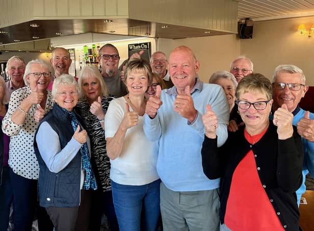 Keith and Janet Tilley, front centre in the pale blue and white jumpers respectively, with some of the volunteers who make the coffee and cake mornings happen, together with some of the more than 70 people who called in on Friday, November 4.