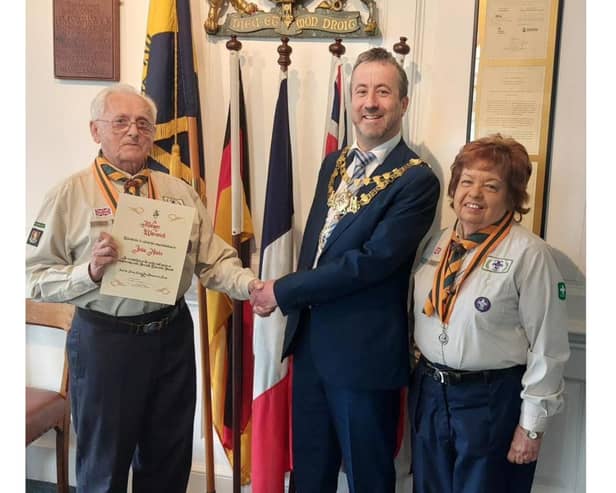 Photo shows John Hinks (left) with his wife Pam while receiving the award from the Mayor of Warwick, Cllr Oliver Jacques. Photo by Warwick Town Council.